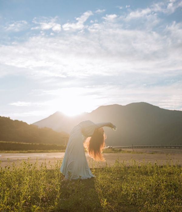 Silhouette of a person in a calm, flowing yoga pose.